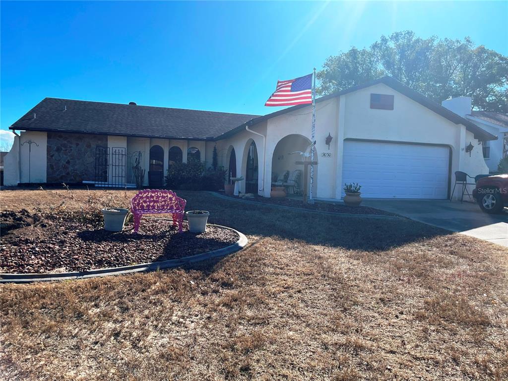 9030 Hernando Way Weeki Wachee, FL 34613 - Photo 2 of 40 a front view of a house with a yard