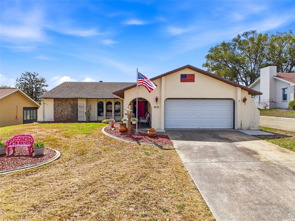 9030 Hernando Way Weeki Wachee, FL 34613 - Photo 2 of 67 a front view of a house with entertaining space