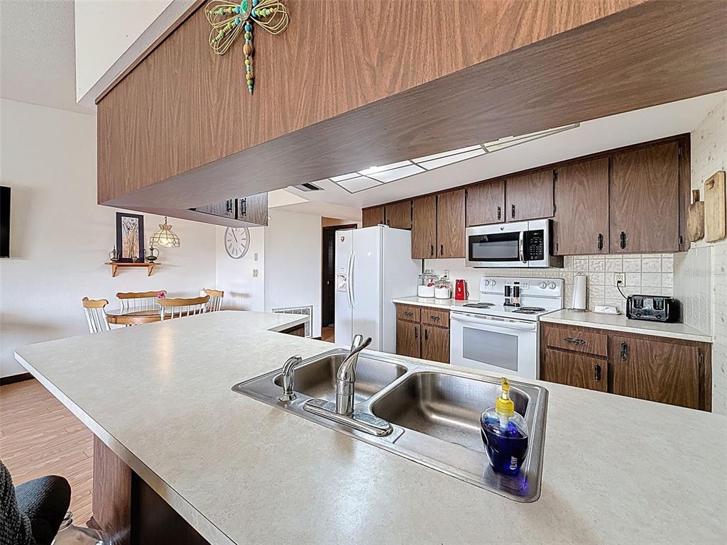 9030 Hernando Way Weeki Wachee, FL 34613 - Photo 23 of 67 a kitchen with stainless steel appliances a refrigerator sink and microwave