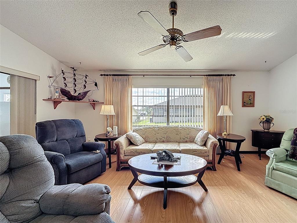 9030 Hernando Way Weeki Wachee, FL 34613 - Photo 27 of 67 a living room with furniture and a large window