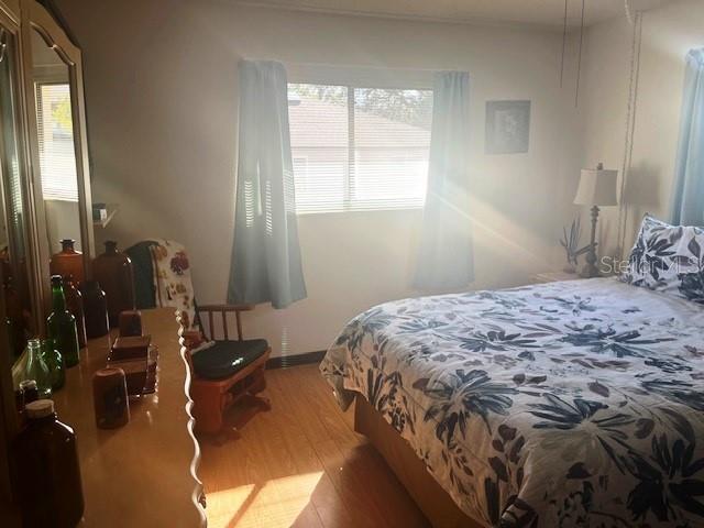 9030 Hernando Way Weeki Wachee, FL 34613 - Photo 27 of 40 a bedroom with a bed and balcony view