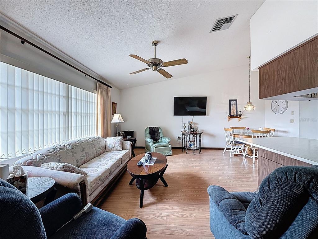 9030 Hernando Way Weeki Wachee, FL 34613 - Photo 29 of 67 a living room with furniture a ceiling fan and a window