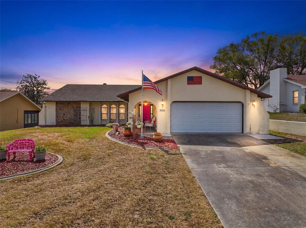 9030 Hernando Way Weeki Wachee, FL 34613 - Photo 3 of 67 a front view of a house with a yard