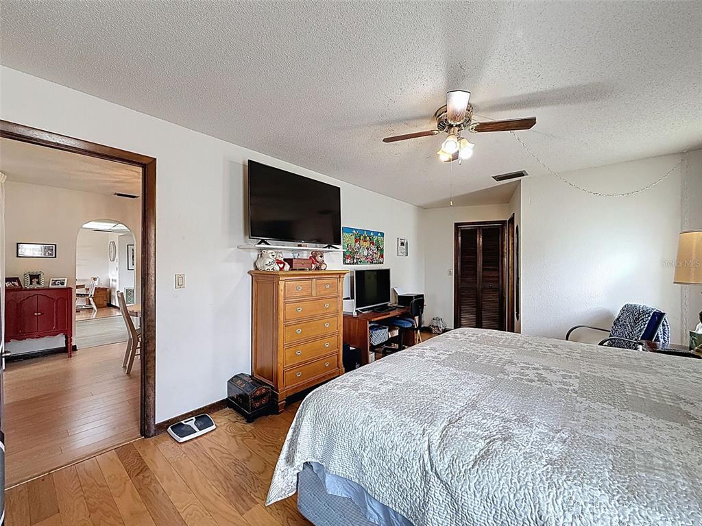 9030 Hernando Way Weeki Wachee, FL 34613 - Photo 32 of 67 a bedroom with a bed and a flat screen tv