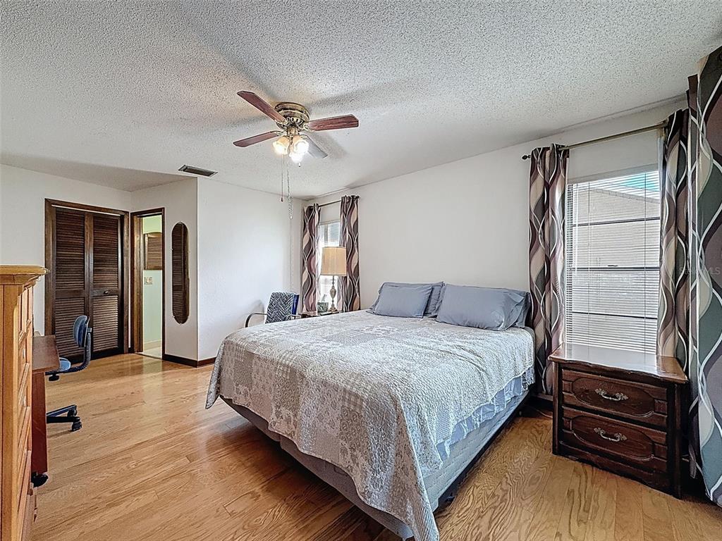 9030 Hernando Way Weeki Wachee, FL 34613 - Photo 33 of 67 a bedroom with a bed and a chandelier
