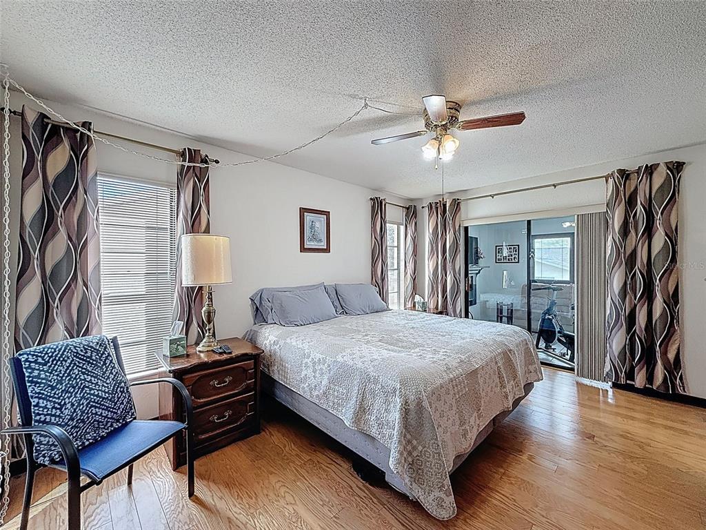 9030 Hernando Way Weeki Wachee, FL 34613 - Photo 34 of 67 a bedroom with a bed couch and a window