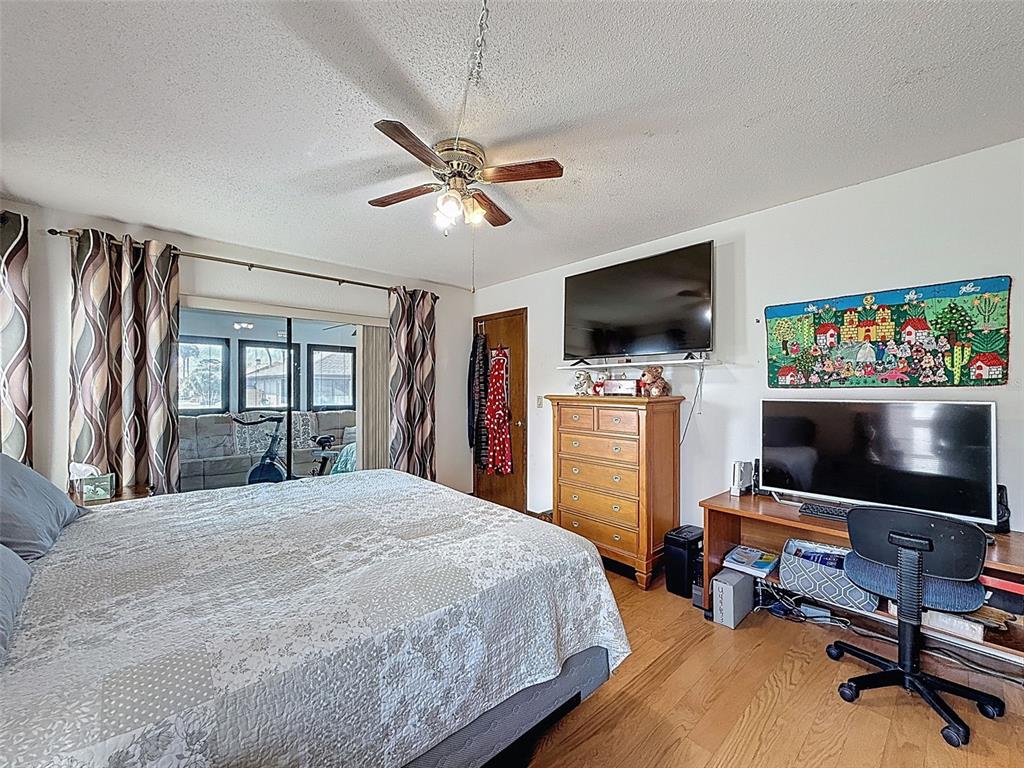 9030 Hernando Way Weeki Wachee, FL 34613 - Photo 35 of 67 a bedroom with a bed and a flat screen tv
