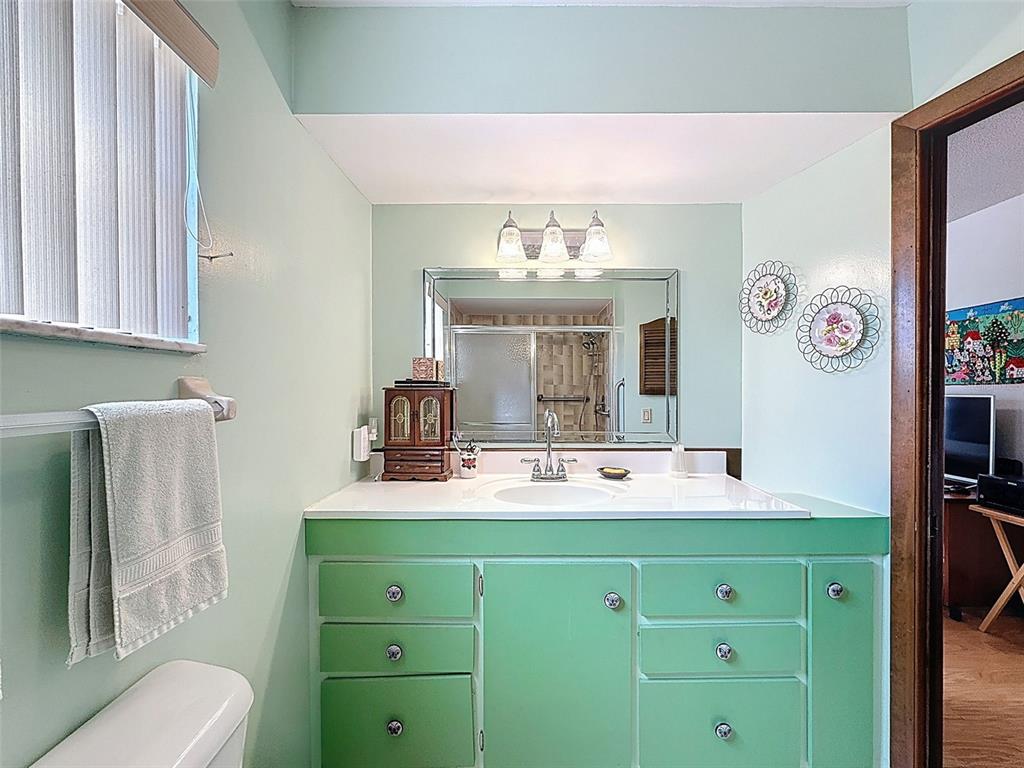 9030 Hernando Way Weeki Wachee, FL 34613 - Photo 37 of 67 a bathroom with a sink mirror and toilet