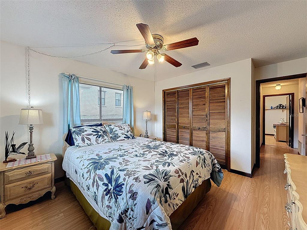 9030 Hernando Way Weeki Wachee, FL 34613 - Photo 41 of 67 a bedroom with a large bed and a chandelier