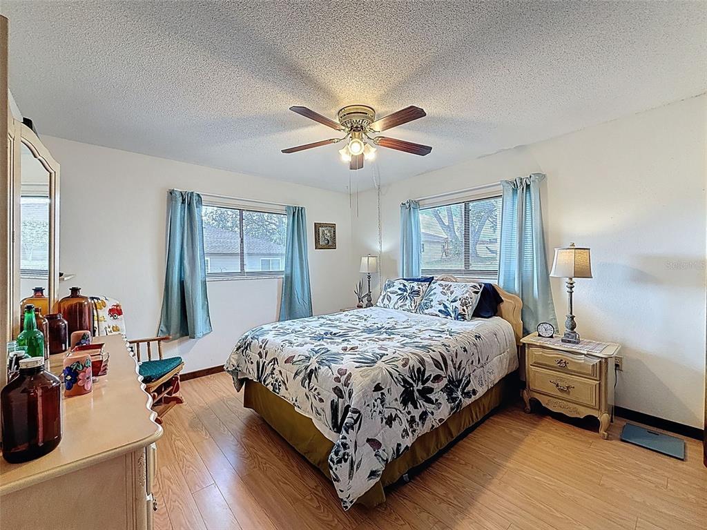 9030 Hernando Way Weeki Wachee, FL 34613 - Photo 42 of 67 a bedroom with a bed and a chandelier
