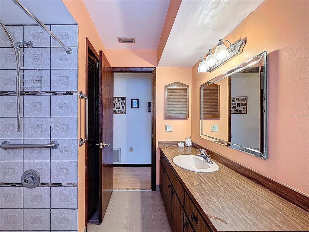 9030 Hernando Way Weeki Wachee, FL 34613 - Photo 46 of 67 a bathroom with a sink and a mirror
