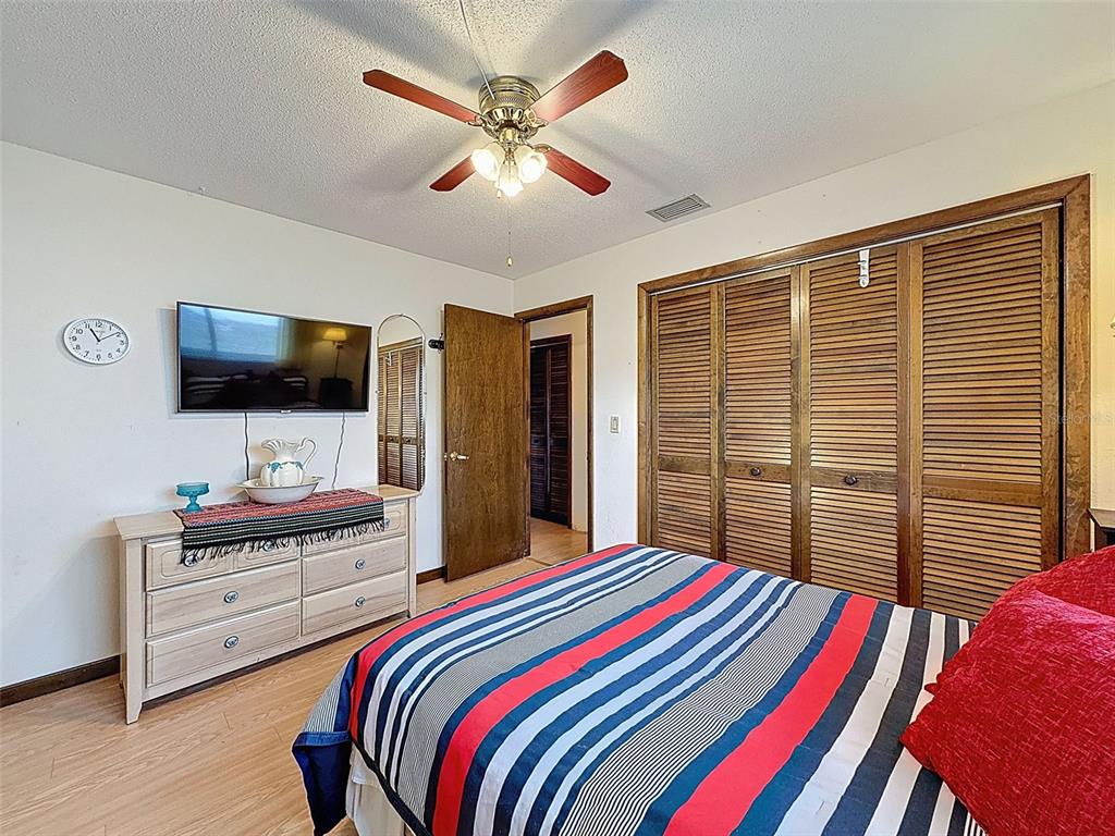9030 Hernando Way Weeki Wachee, FL 34613 - Photo 47 of 67 a bedroom with a bed and a flat screen tv
