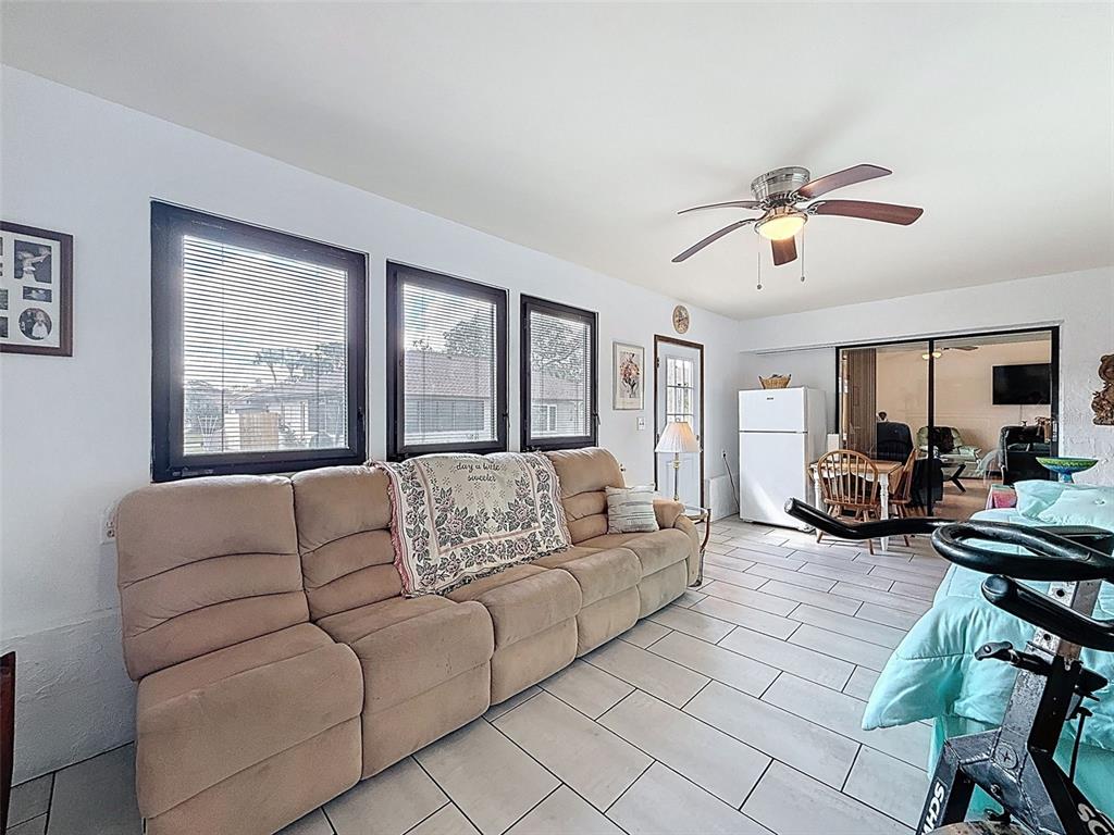 9030 Hernando Way Weeki Wachee, FL 34613 - Photo 52 of 67 a living room with furniture ceiling fan and a window