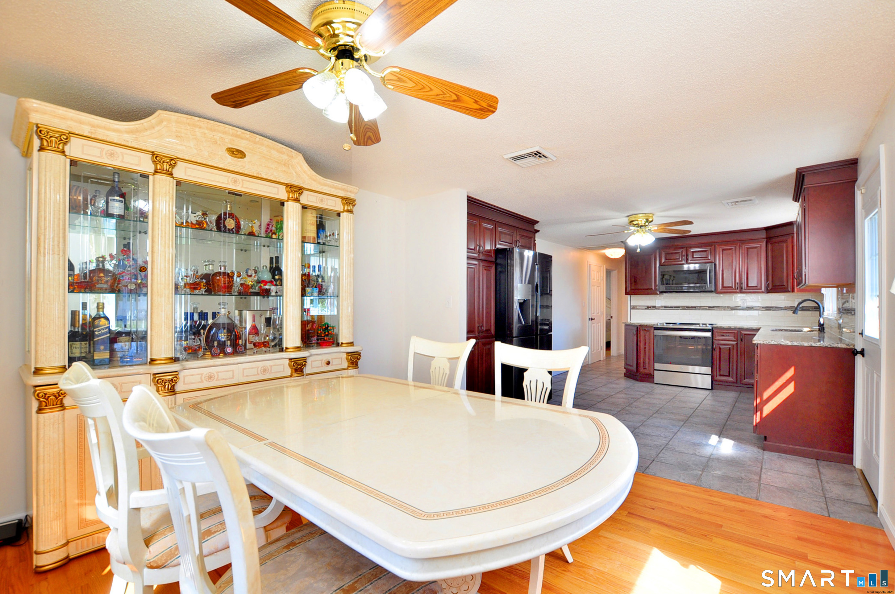 234 South Elm Street Windsor Locks, CT 06096 - Photo 11 of 33 a living room with stainless steel appliances furniture a chandelier and a dining table