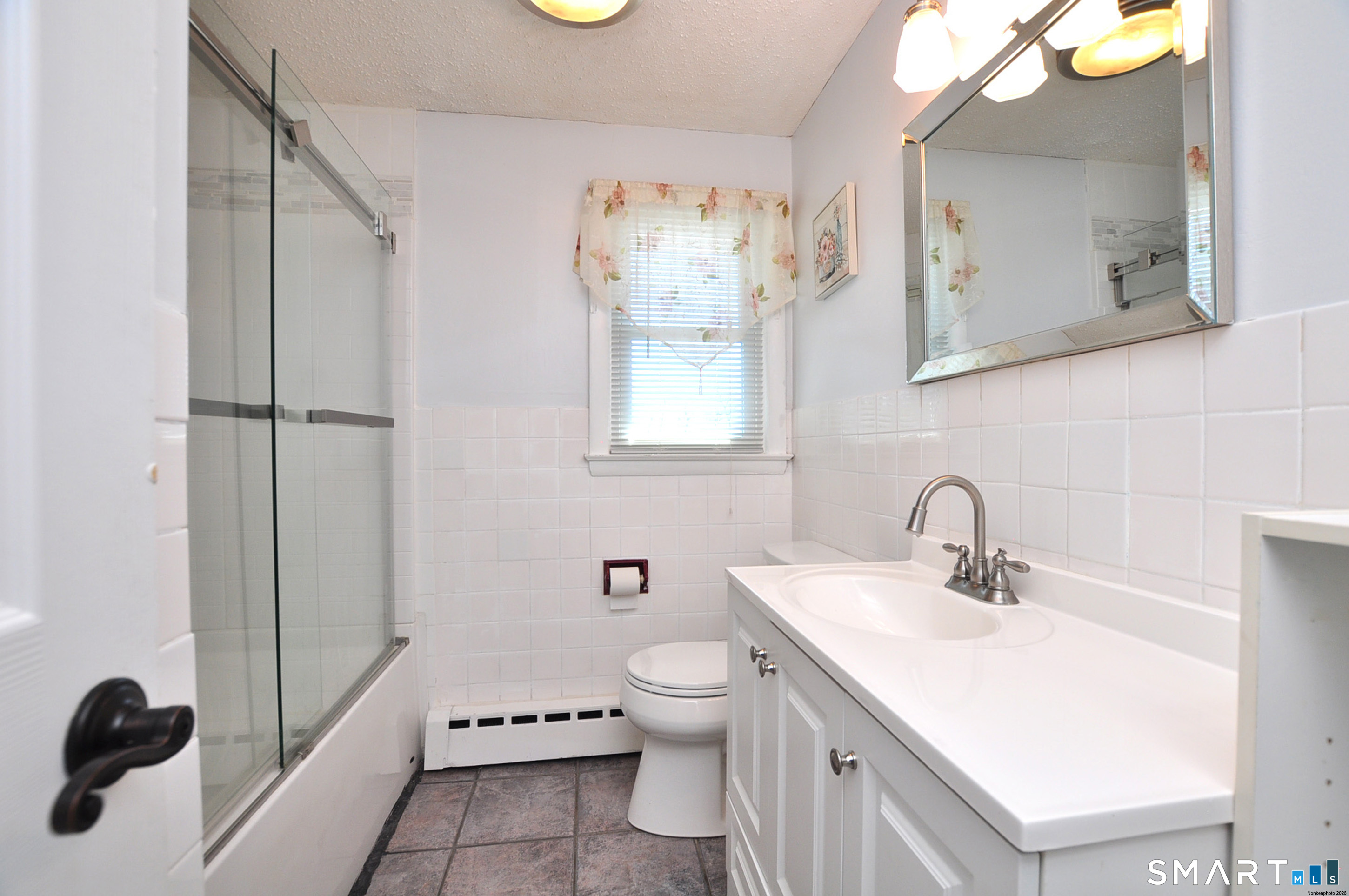 234 South Elm Street Windsor Locks, CT 06096 - Photo 15 of 33 a bathroom with a sink a toilet and a mirror