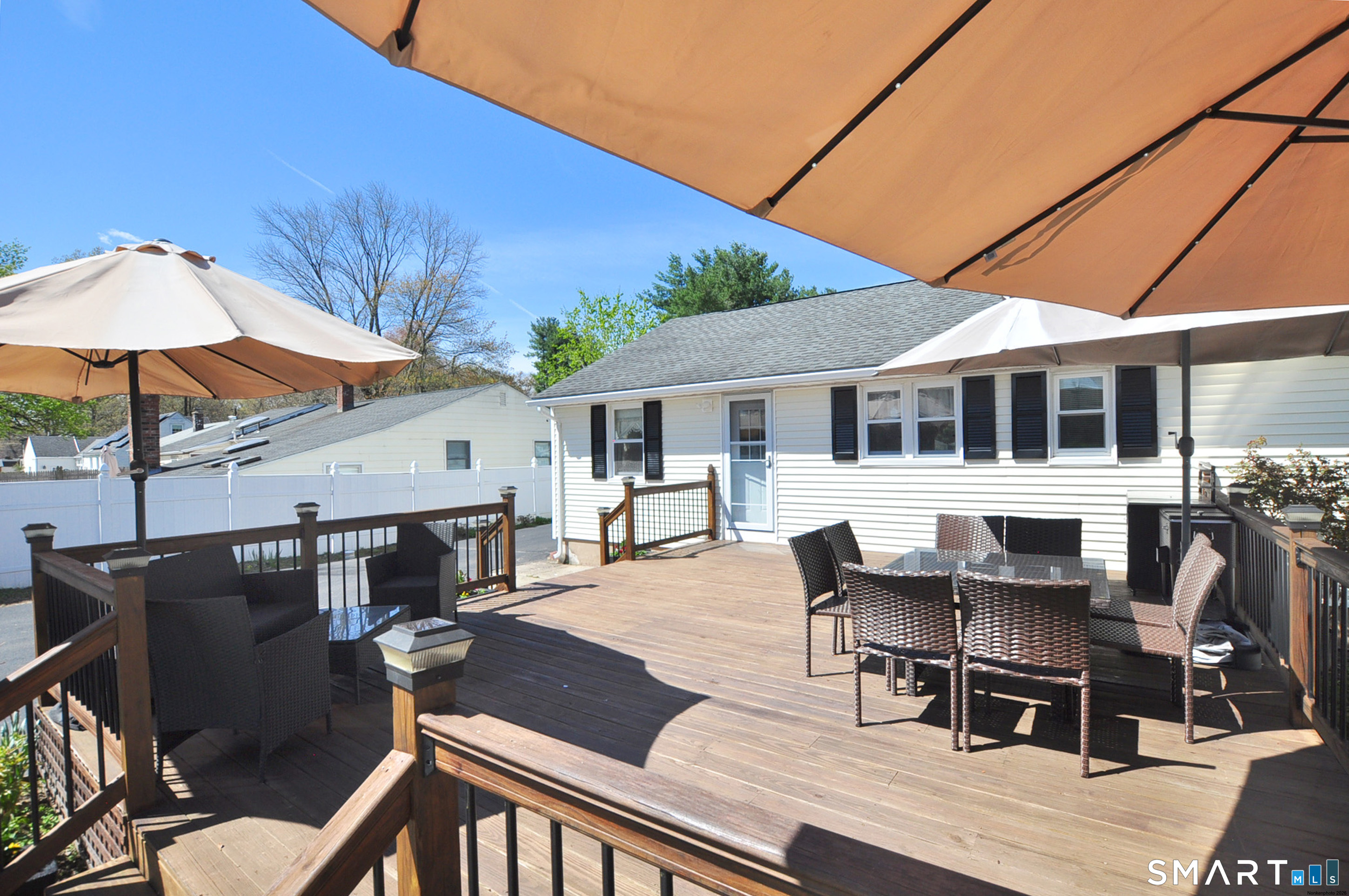 234 South Elm Street Windsor Locks, CT 06096 - Photo 28 of 33 a patio with couches table and chairs under an umbrella