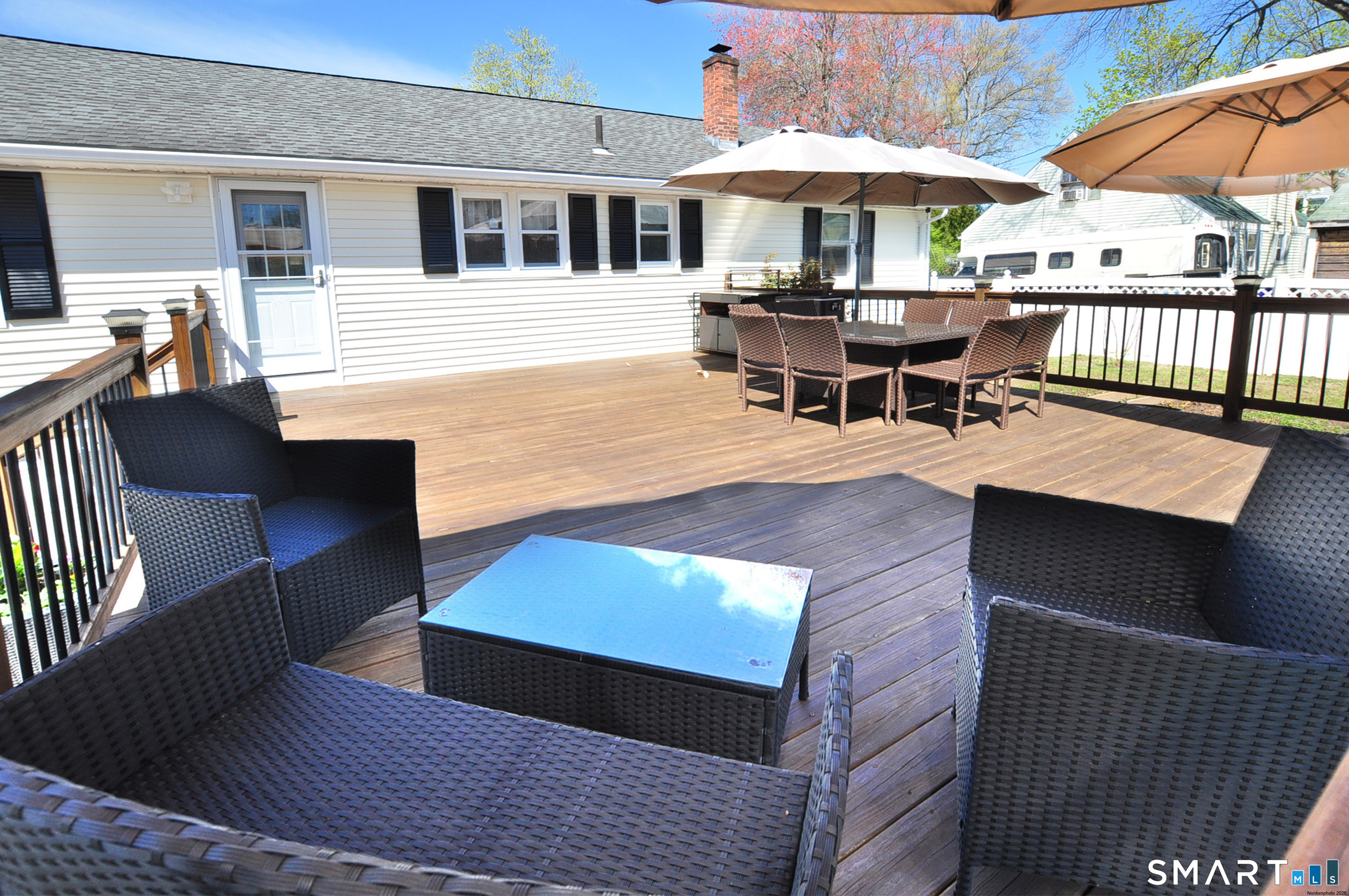 234 South Elm Street Windsor Locks, CT 06096 - Photo 30 of 33 a view of a patio with table and chairs under an umbrella with wooden floor