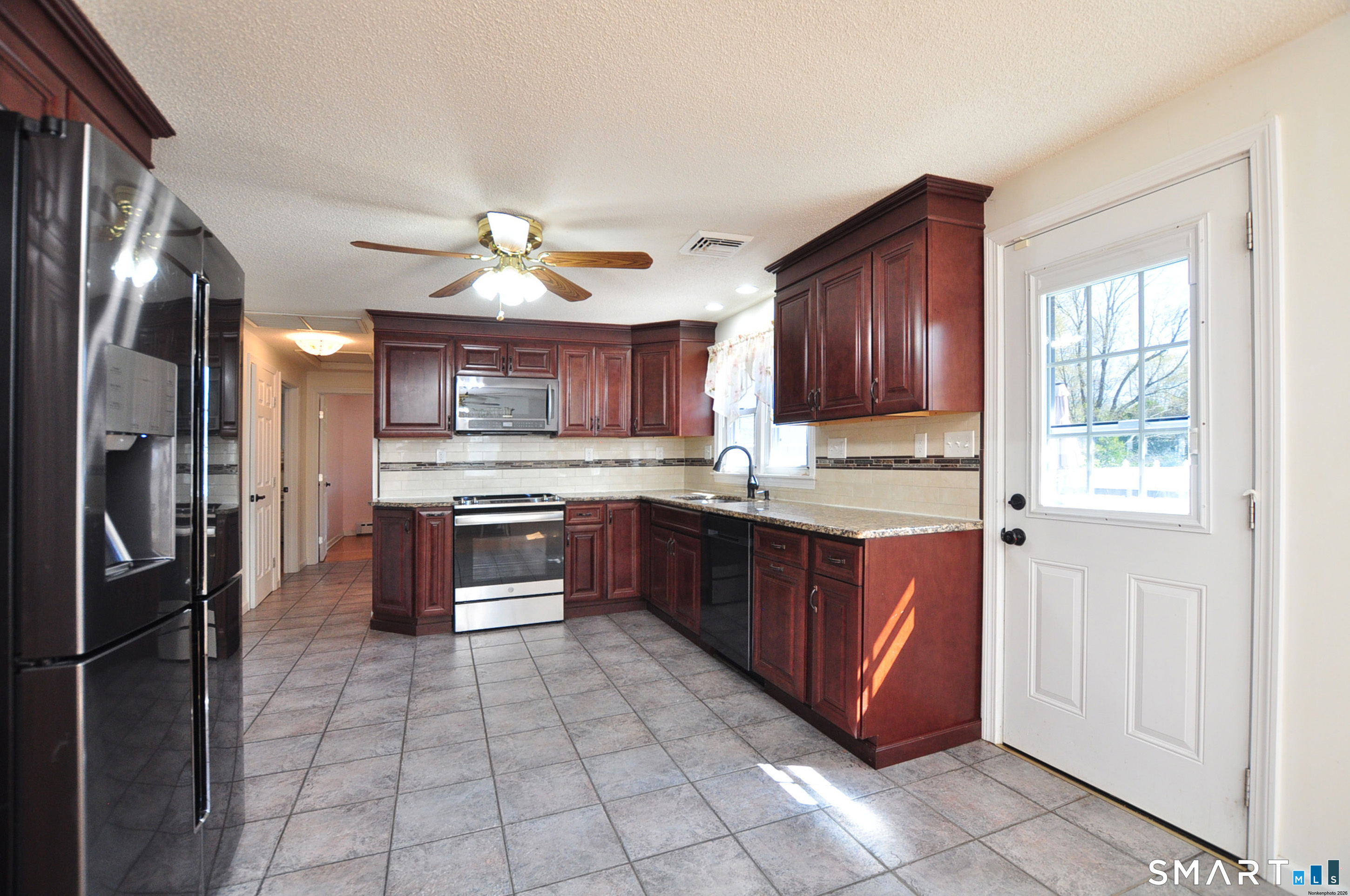 234 South Elm Street Windsor Locks, CT 06096 - Photo 6 of 33 a large kitchen with granite countertop a stove a refrigerator and a sink