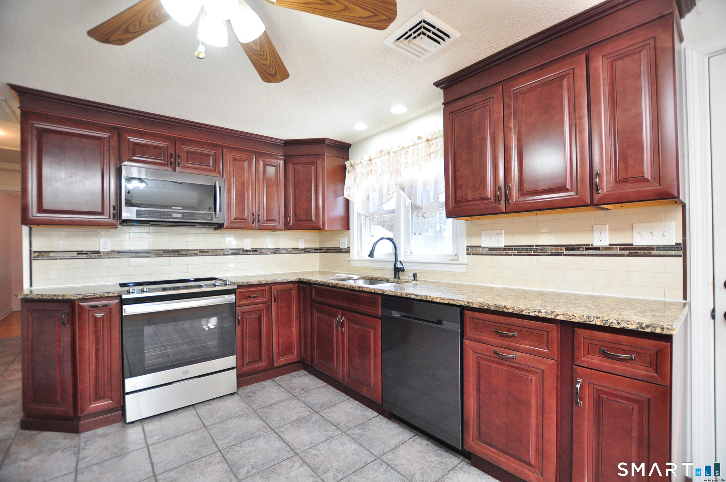 234 South Elm Street Windsor Locks, CT 06096 - Photo 7 of 33 a kitchen with stainless steel appliances granite countertop wooden cabinets a sink and dishwasher
