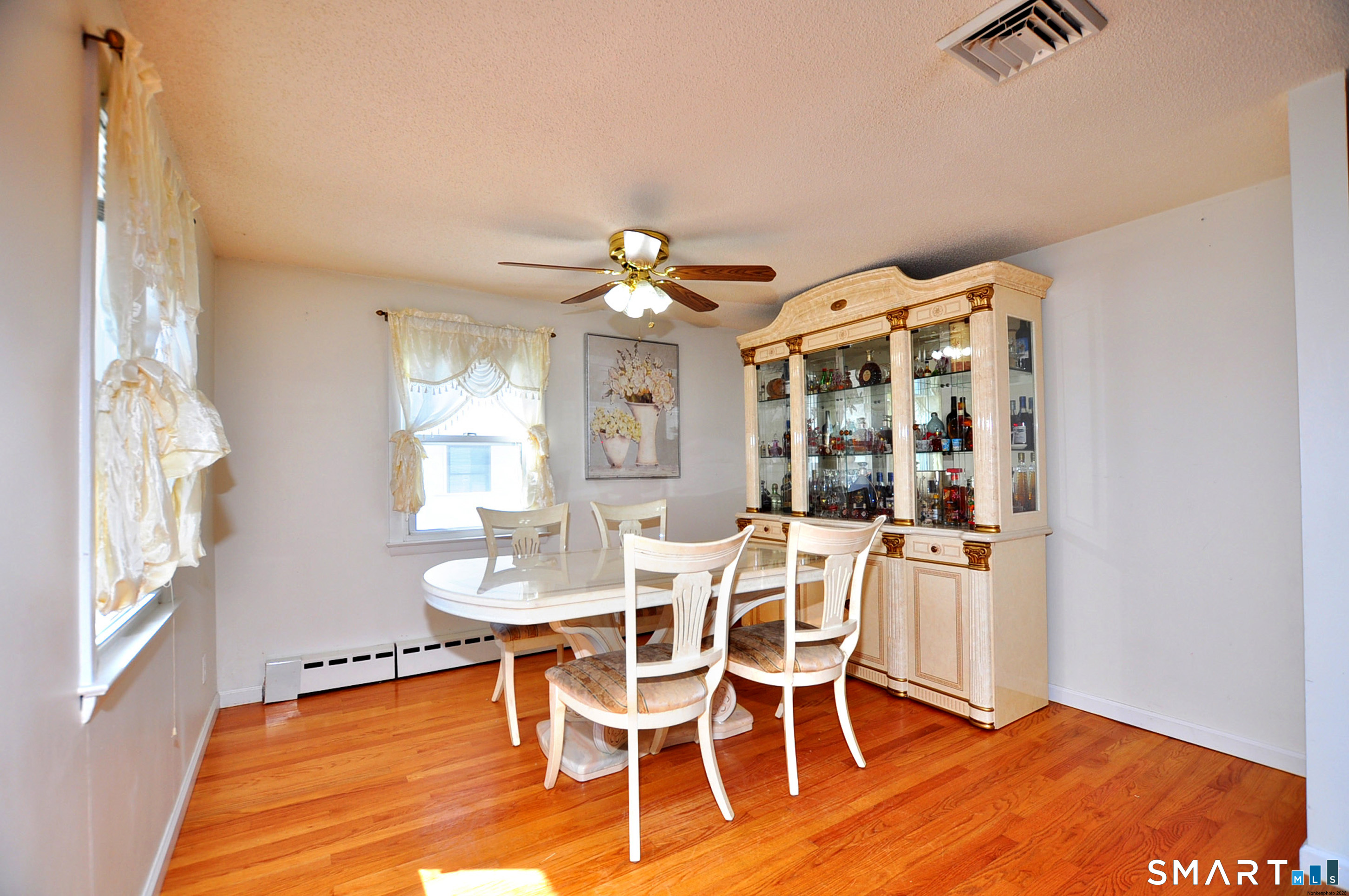 234 South Elm Street Windsor Locks, CT 06096 - Photo 10 of 33 a dining room with wooden floor a chandelier a glass table and chairs