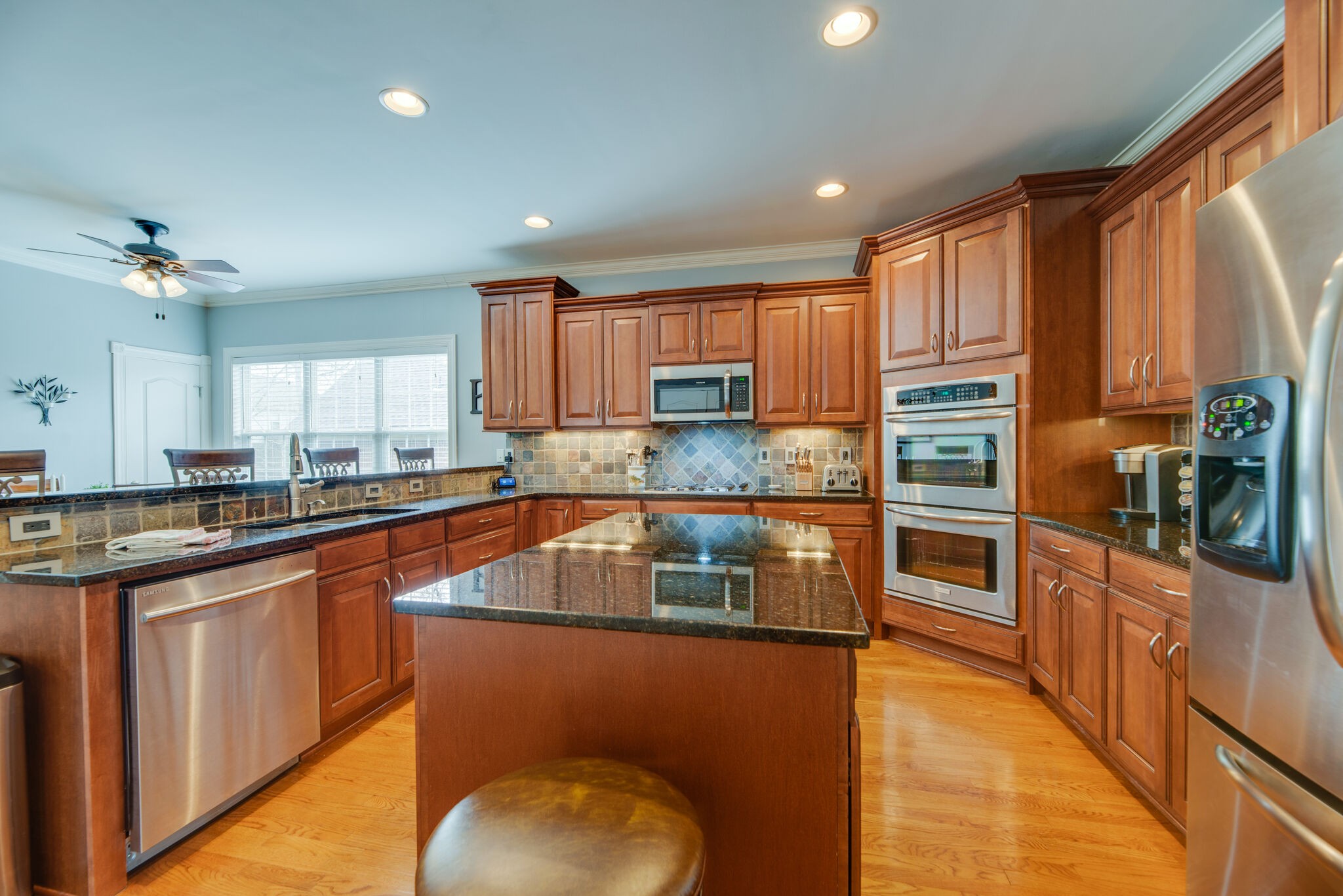 1215 White Rock Road Spring Hill, TN 37174 - Photo 14 of 42 a kitchen with stainless steel appliances granite countertop a sink stove and refrigerator