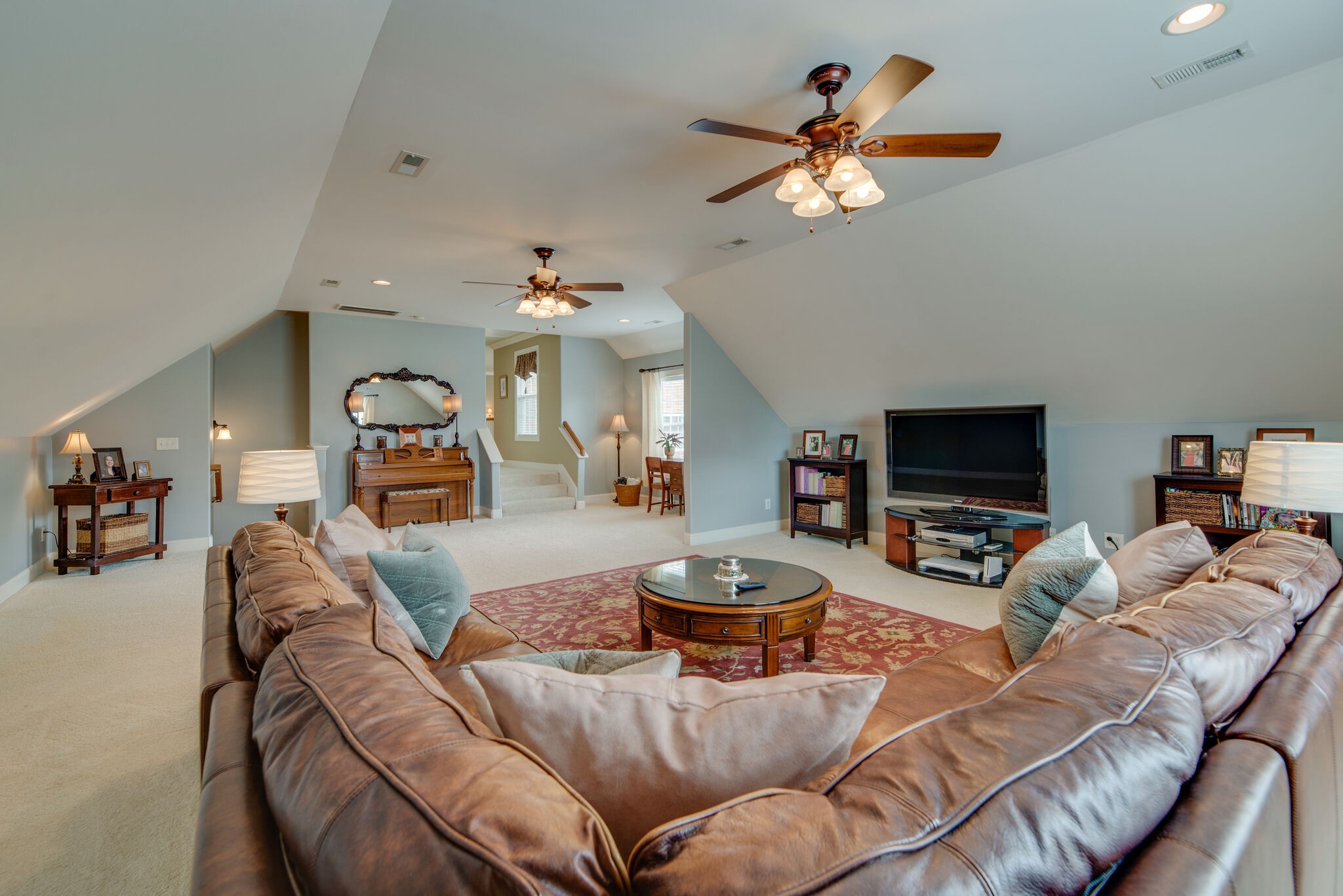 1215 White Rock Road Spring Hill, TN 37174 - Photo 36 of 42 a living room with furniture a chandelier and a flat screen tv
