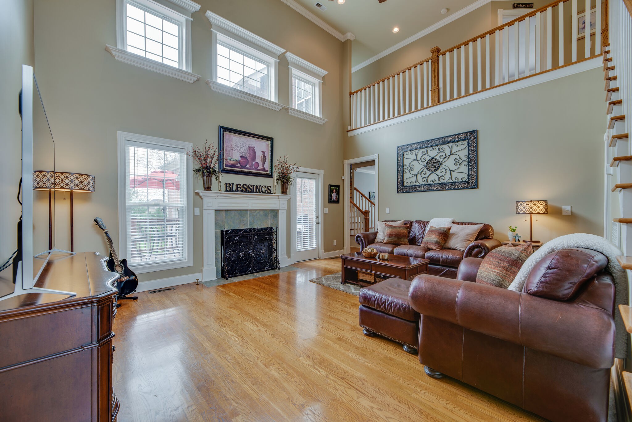 1215 White Rock Road Spring Hill, TN 37174 - Photo 8 of 42 a living room with furniture a fireplace and a flat screen tv