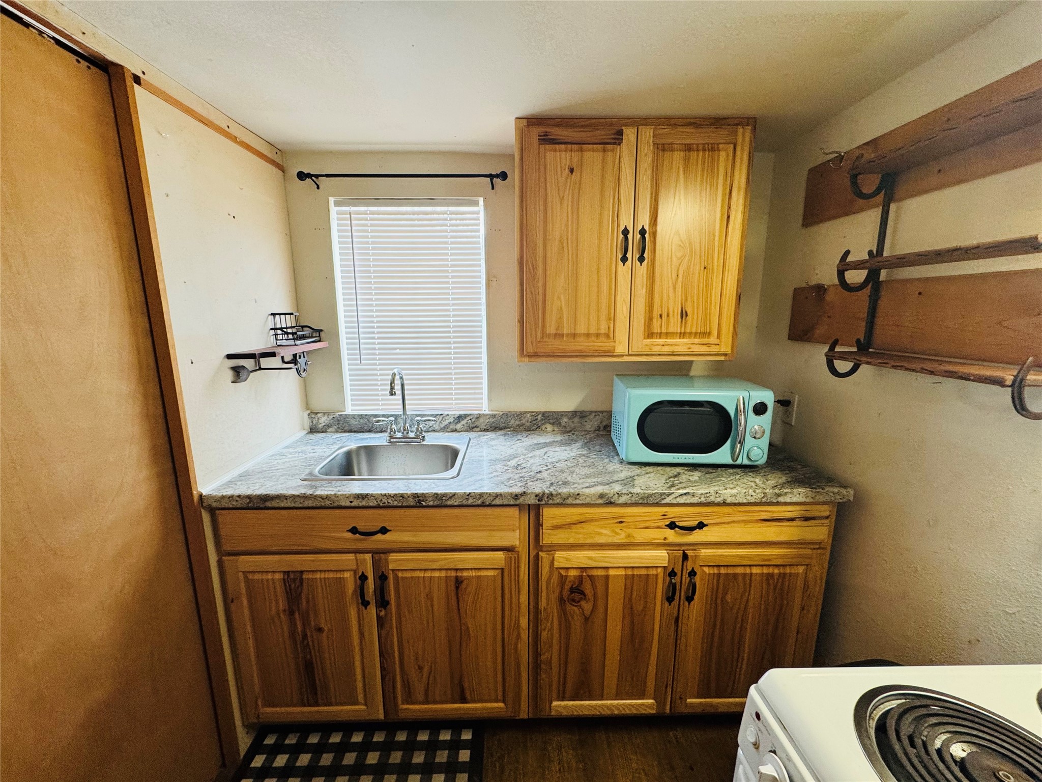 2071 Camp Seale Road Livingston, TX 77351 - Photo 12 of 28 a bathroom with a granite countertop sink a mirror a vanity and a shower