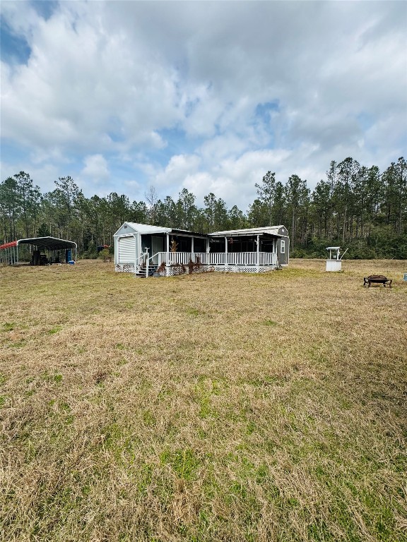 2071 Camp Seale Road Livingston, TX 77351 - Photo 2 of 28 a view of a lake with a house in the background