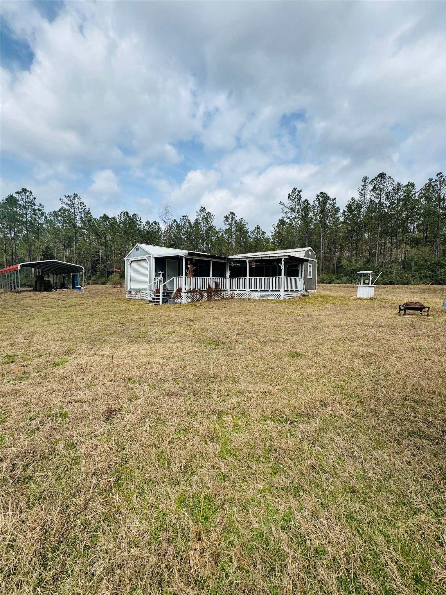 2071 Camp Seale Road Livingston, TX 77351 - Photo 2 of 28 a view of a lake with a house in the background