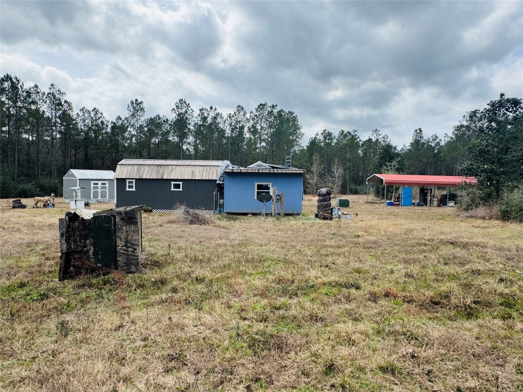 2071 Camp Seale Road Livingston, TX 77351 - Photo 10 of 28 a view of a house with yard and sitting area