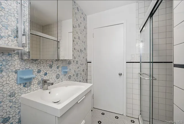 a bathroom with a sink and shower
