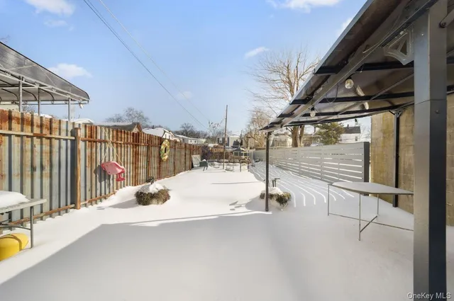a view of a street with wooden fence