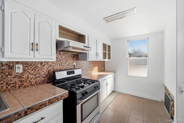 a kitchen with granite countertop a stove and a sink