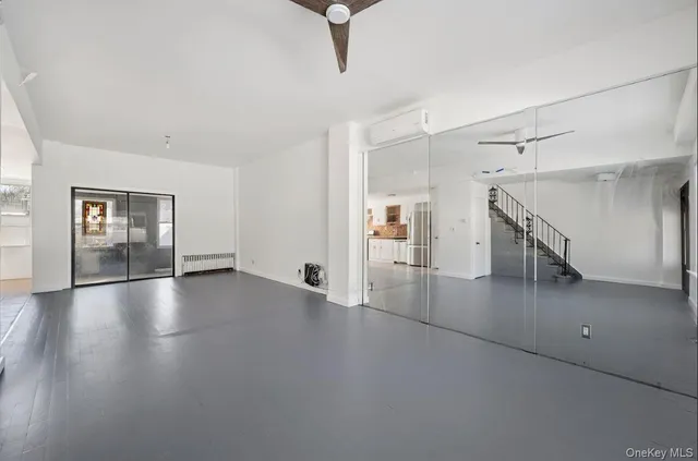 an empty room with windows and stairs