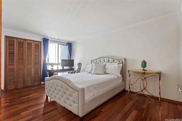 a bedroom with a bed and a mirror