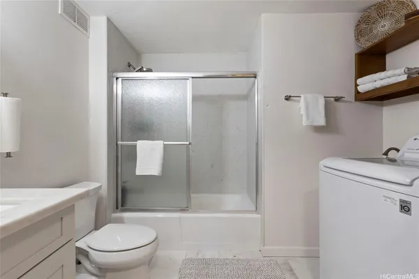 a bathroom with a bathtub toilet and a shower