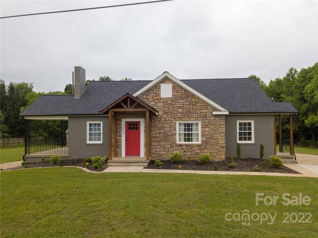 a front view of house with yard and green space