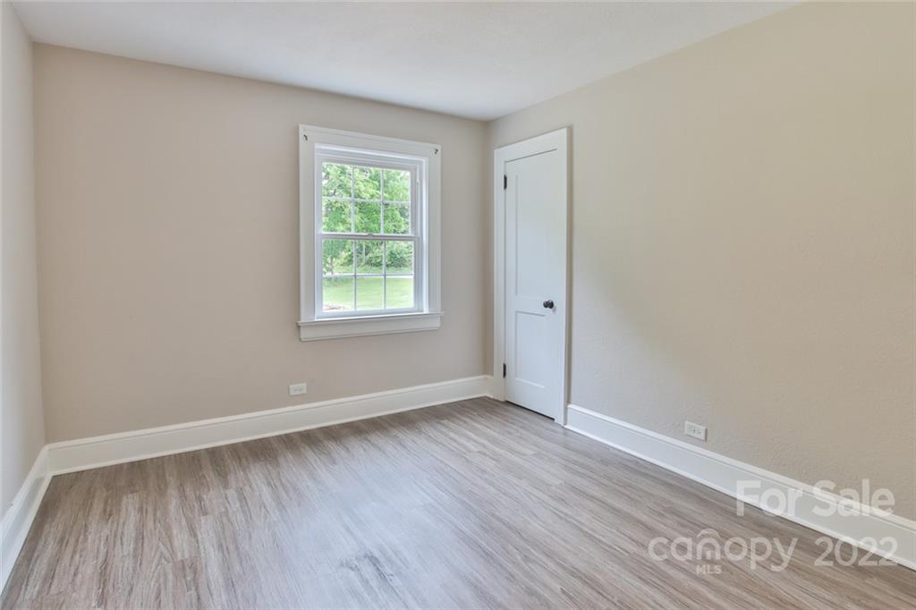 263 McCrary Place Lenoir, NC 28645 - Photo 16 of 40 an empty room with wooden floor and windows