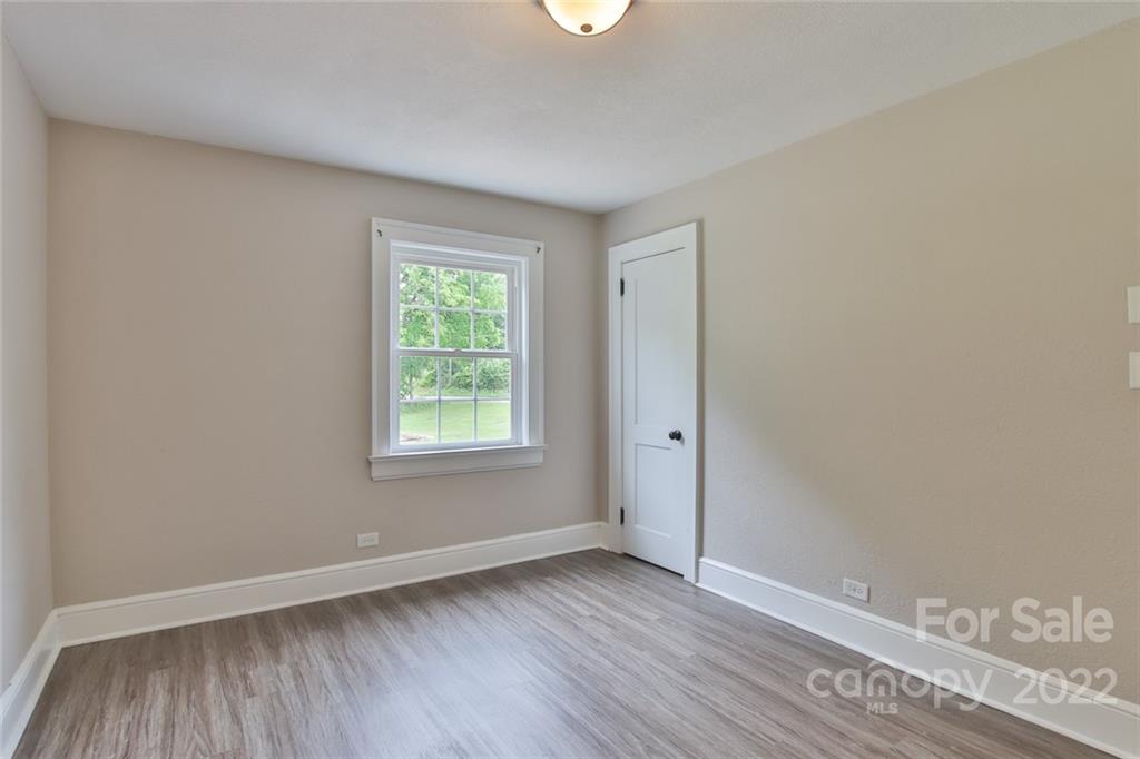 263 McCrary Place Lenoir, NC 28645 - Photo 17 of 40 a view of an empty room with wooden floor and a window