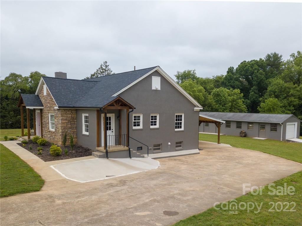 263 McCrary Place Lenoir, NC 28645 - Photo 24 of 40 a front view of a house with a yard and potted plants