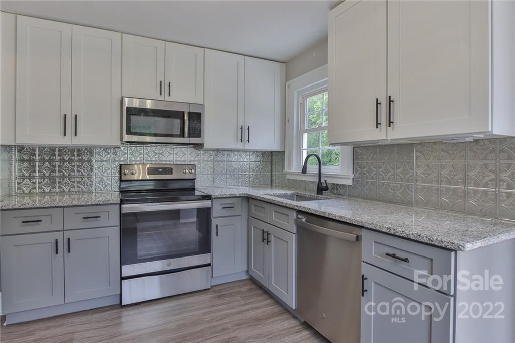 263 McCrary Place Lenoir, NC 28645 - Photo 4 of 40 a kitchen with stainless steel appliances granite countertop a sink stove and microwave