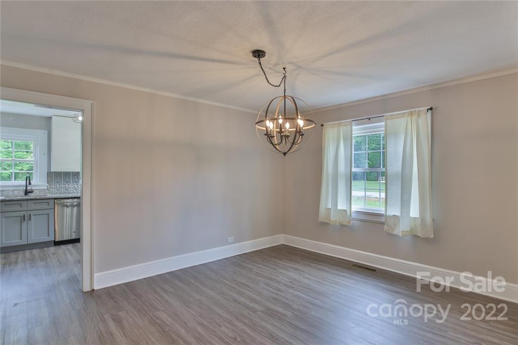 263 McCrary Place Lenoir, NC 28645 - Photo 6 of 40 an empty room with wooden floor and windows