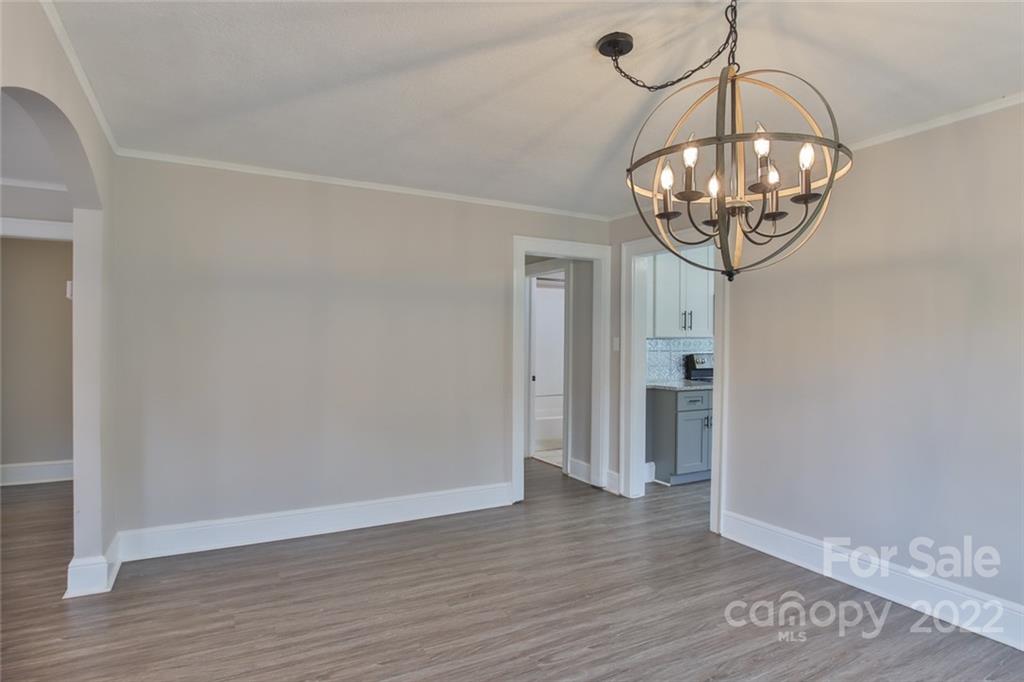 263 McCrary Place Lenoir, NC 28645 - Photo 7 of 40 a view of a hallway with wooden floor and chandelier