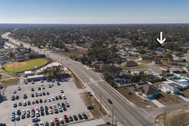 a aerial view of a house with a garden and yard