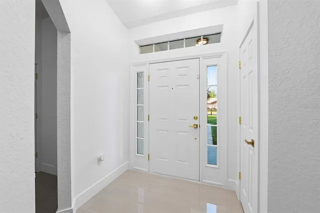 a view of a kitchen with a sink and refrigerator