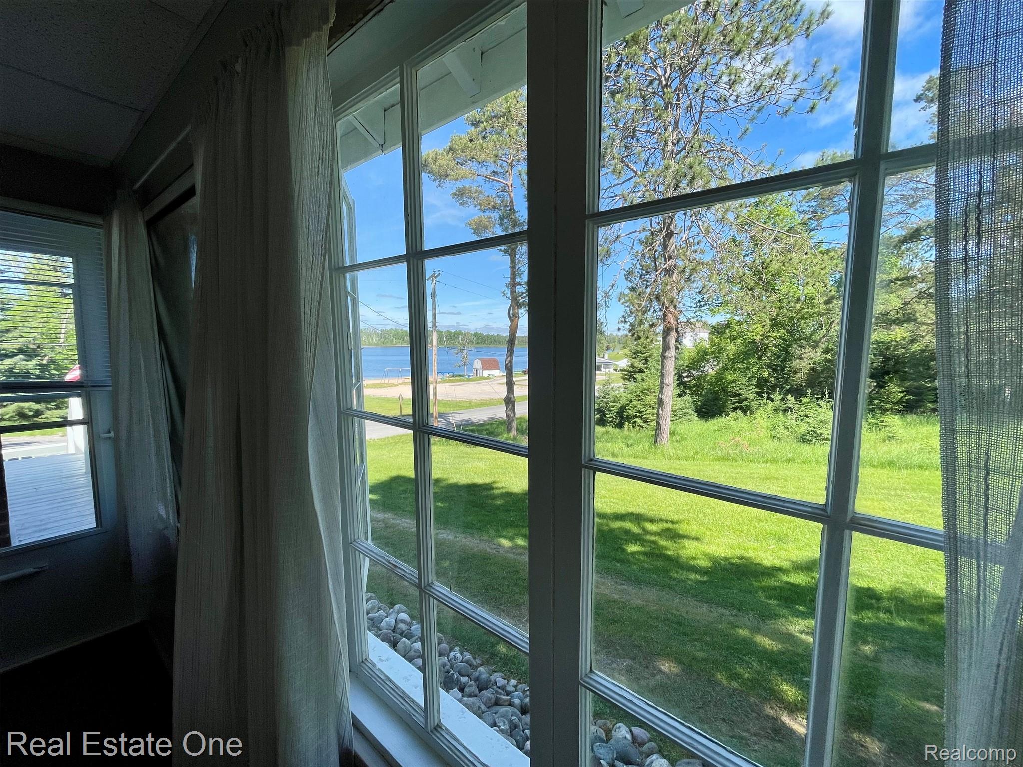 4160 Hawk Road Lincoln, MI 48742 - Photo 27 of 48 Large grid-pattern window offering abundant natural light and an expansive outdoor scene