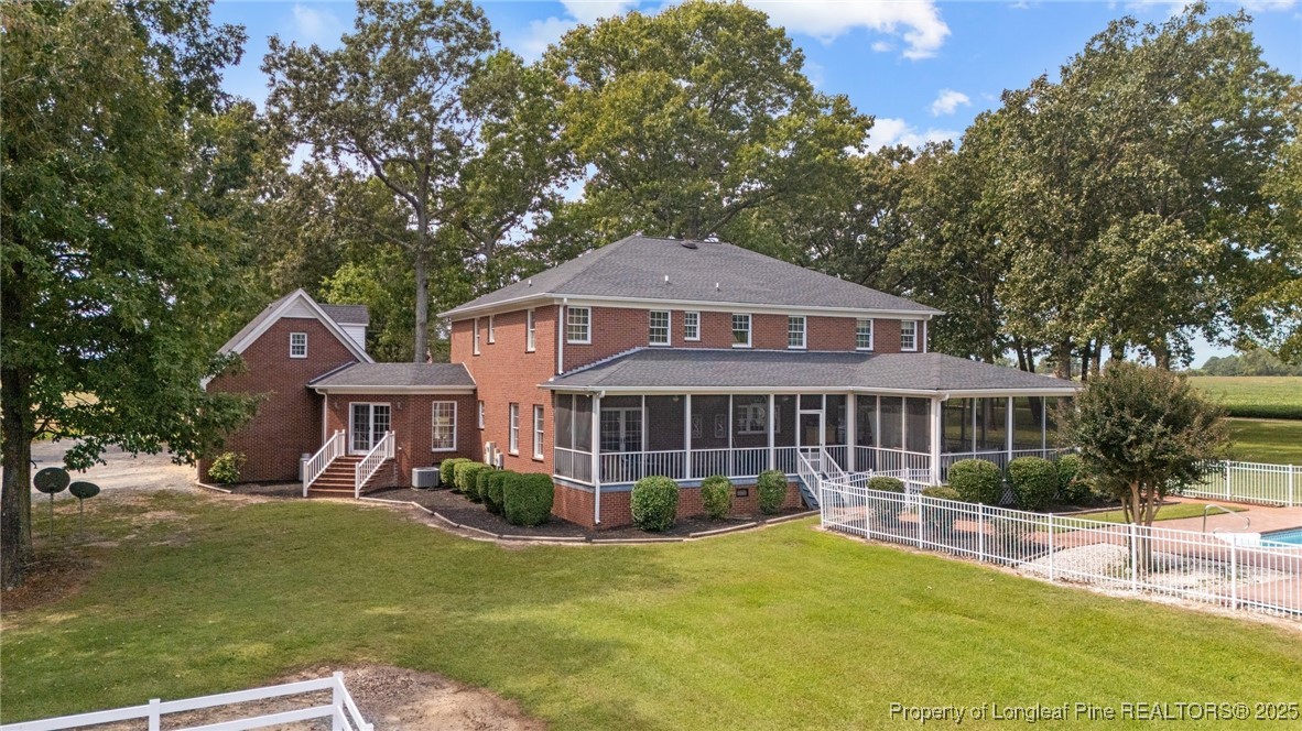 387 3 Bridge Road Dunn, NC 28334 - Photo 13 of 49 a front view of a house with a yard table and chairs