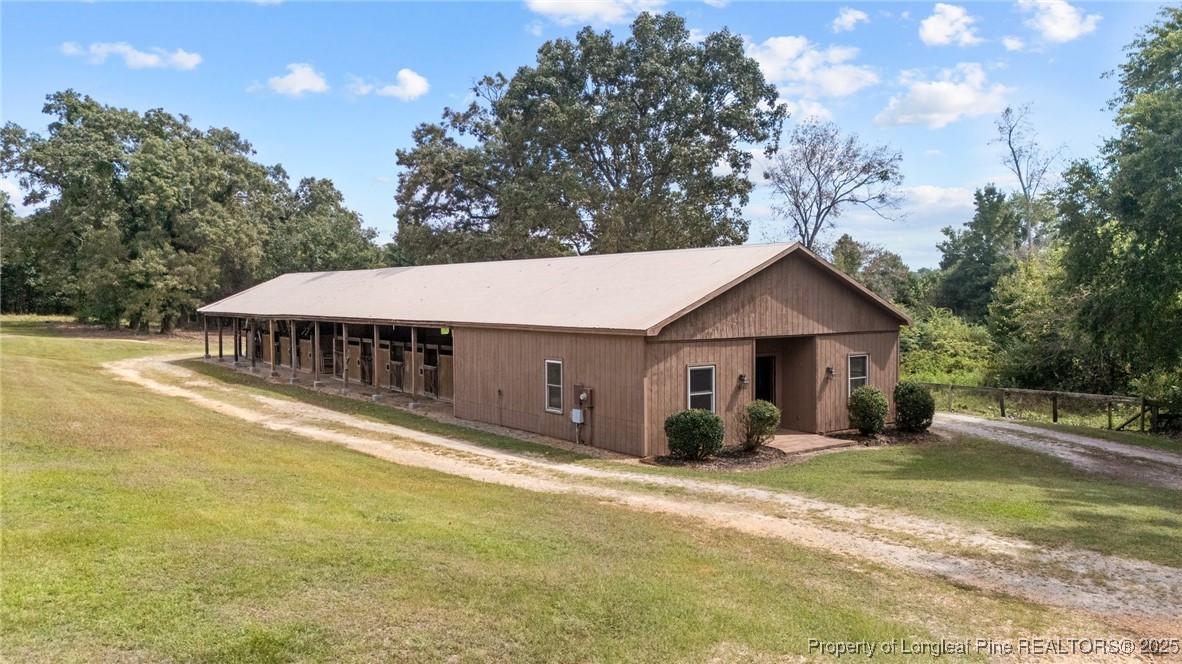 387 3 Bridge Road Dunn, NC 28334 - Photo 16 of 49 a view of a house with backyard and trees