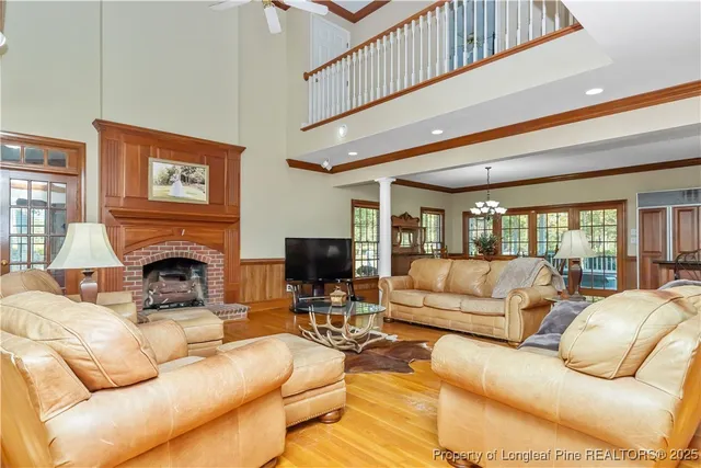 a living room with furniture a fireplace and a flat screen tv